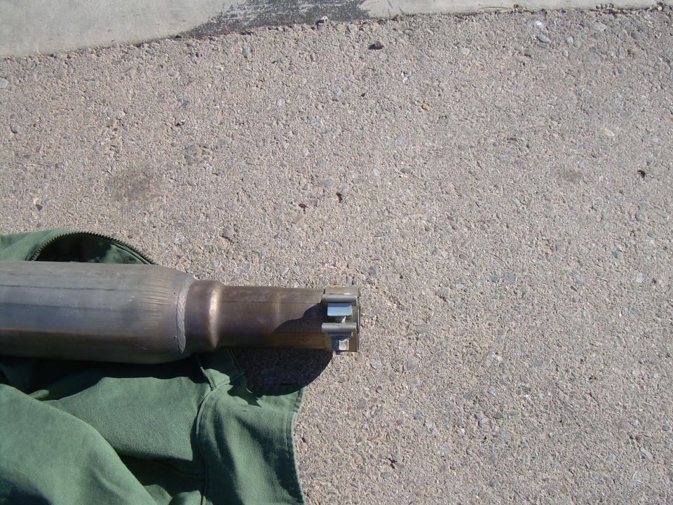 Exhaust pipe with clamp connection on green fabric