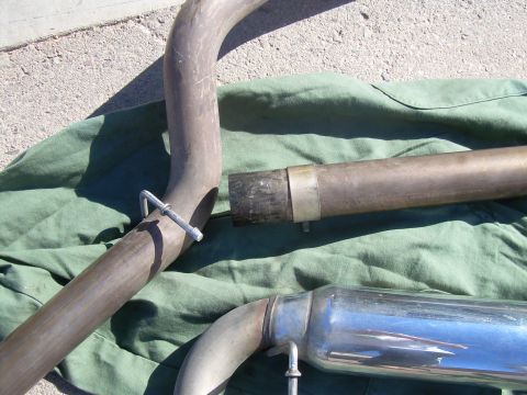 1996 Ford Probe - Exhaust system components, including pipes and a muffler, are shown on a green cloth.