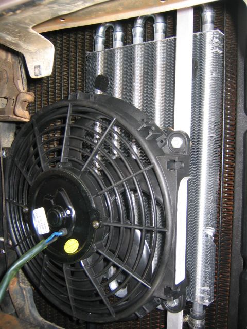 1979 Ford Bronco - Close-up view of a radiator fan and an auxiliary oil cooler mounted in front of the main radiator.