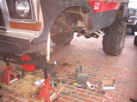 1979 Ford Bronco - Front axle rebuild in progress on a 1979 Ford Bronco, parts laid out on the brick driveway.