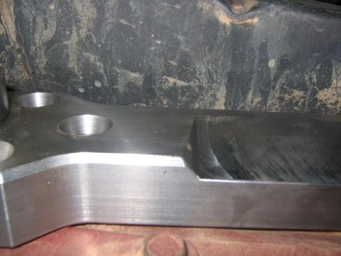 1979 Ford Bronco - Machined metal part with circular recesses and a cut-out section, likely for automotive repair or modification.