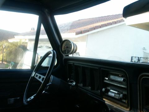 1978 Ford Bronco - Interior view of a 1978 Ford Bronco, a custom gauge and original dashboard components.
