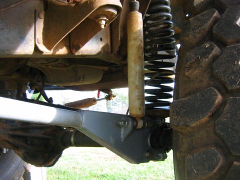 1992 Ford Mustang - Detail shot of off-road suspension components, a shock absorber, coil spring, and part of a tire.