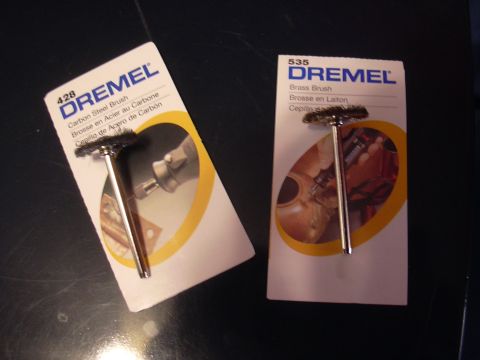 1996 Ford Crown Victoria - Two Dremel brand wire brushes are shown in their original packaging on a dark surface.