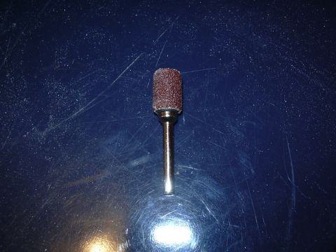 1996 Ford Crown Victoria - A sanding drum bit is shown against a blue, scratched surface.