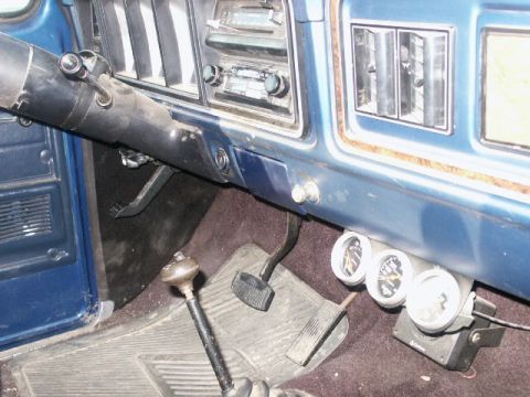 1978 Ford Bronco - Interior view of a 1978 Ford Bronco, showing the dashboard, pedals, and aftermarket gauges.