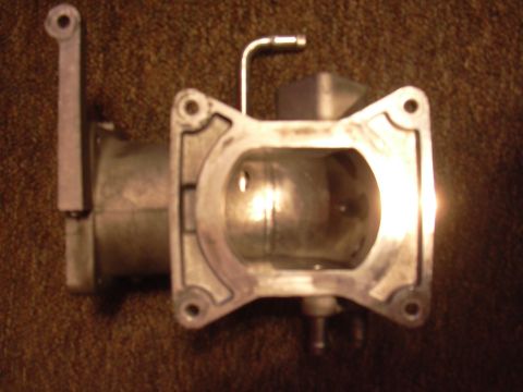 1996 Ford Crown Victoria - This is a close-up view of a throttle body, a component of the engine's air intake system.