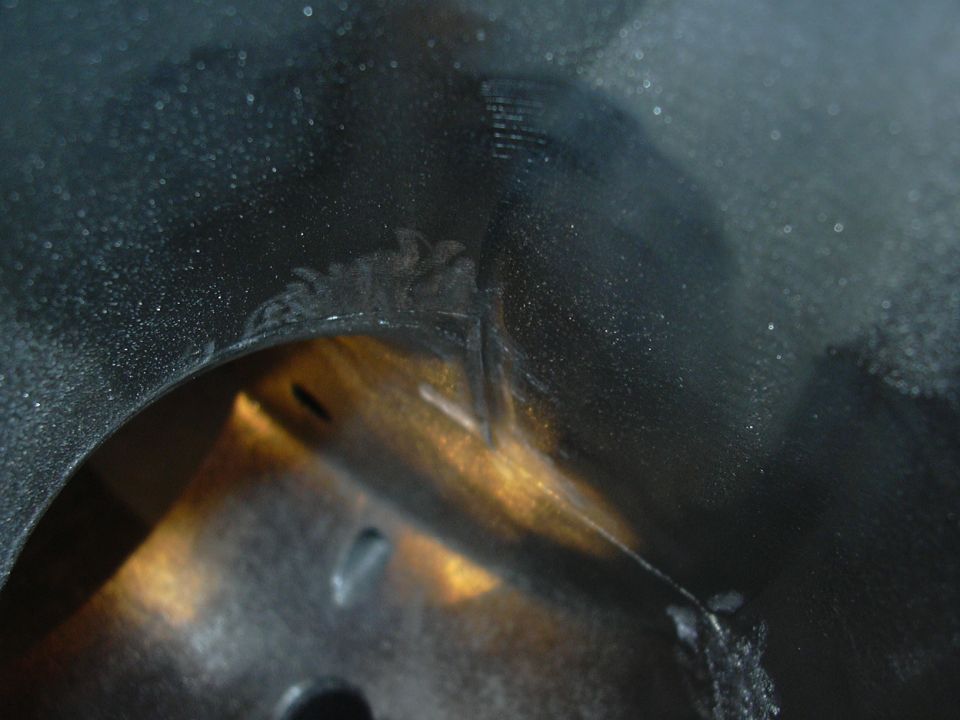 Close-up of engine bay part with Supermotors.net watermark