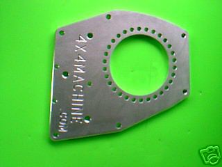 1995 Ford Bronco - Adapter plate with text and circular pattern of holes against a green background.