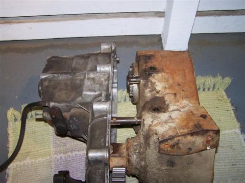 1995 Ford Bronco - Two transmission components, one showing significant rust and wear, are placed next to each other.