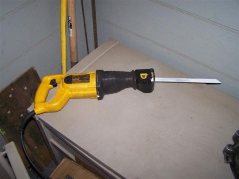 1995 Ford Bronco - A yellow and black reciprocating saw is shown on a flat surface, with a metal blade extended.