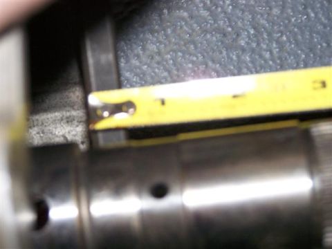 1995 Ford Bronco - A close-up shows a yellow measuring tape positioned over a metal component, with visible text at the bottom right.