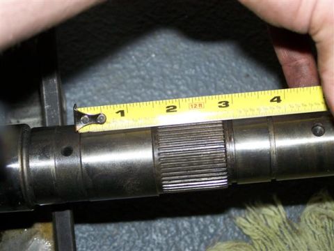 1995 Ford Bronco - A tape measure is used to measure a splined shaft, with markings visible from 1 to 4 inches.