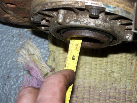 1995 Ford Bronco - A tape measure is used to check the dimensions of a vehicle's mechanical part.