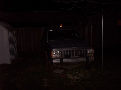 1987 Jeep Cherokee - Front view of a 1987 Jeep Cherokee parked outdoors at night.
