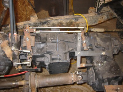 1995 Ford Bronco - Close-up of a vehicle's transfer case and transmission assembly, showing linkage components.