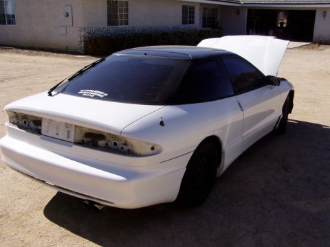 1993 Ford Probe - This 1993 Ford Probe is shown with its hood open and the rear quarter panel visible, suggesting it is undergoing modifications.