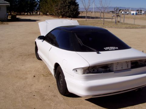 1993 Ford Probe - Rear view of a white 1993 Ford Probe, hood is open, parked outdoors.