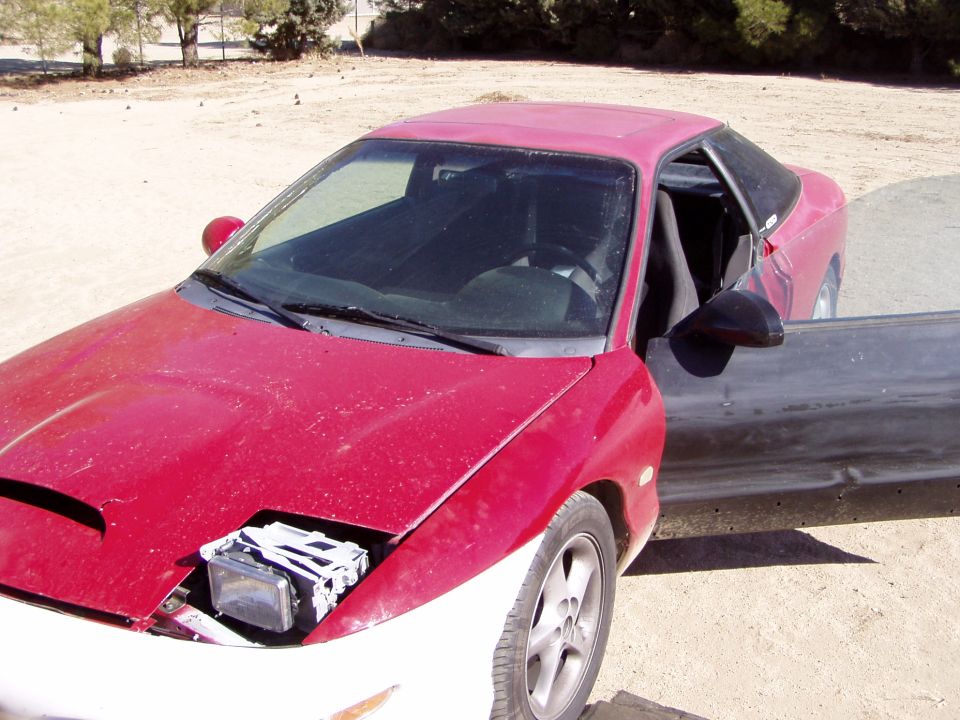 1993 Ford Probe 3q-front view with driver door open and headlight housing exposed