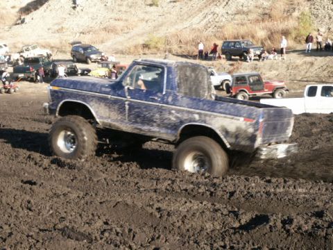 1978 Ford Bronco - Muddy 1978 Ford Bronco navigating difficult terrain.