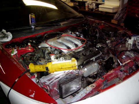 1993 Ford Probe - The engine bay of a car is shown with the engine removed, revealing the internal components and wiring.