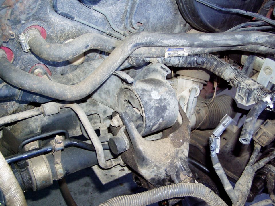 Engine mount with hoses and wiring visible