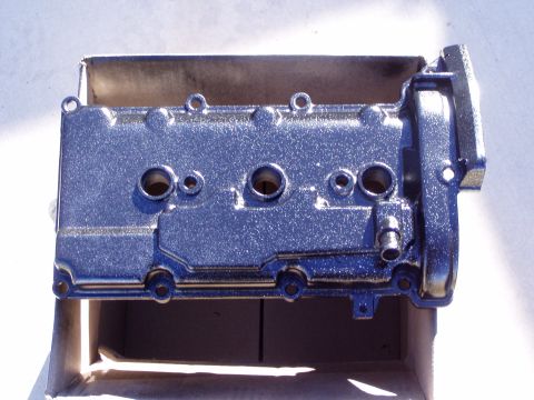 1993 Ford Probe - A chrome valve cover, likely for an engine swap, is shown in a cardboard box.