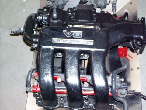 1993 Ford Probe - Engine intake manifold with V6 DOHC markings and red fuel rails.