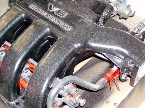 1993 Ford Probe - This is a close-up view of a V6 DOHC 24-valve engine intake manifold, showing fuel injectors and associated plumbing.