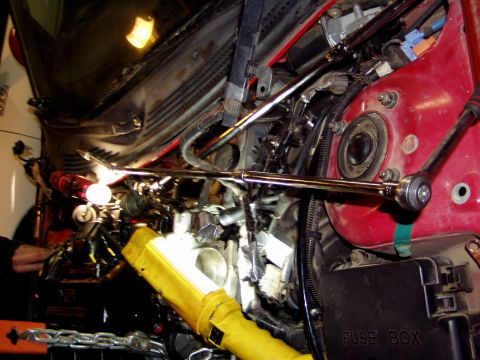 1993 Ford Probe - Close-up view of a car's engine bay with tools being used for maintenance or repair.