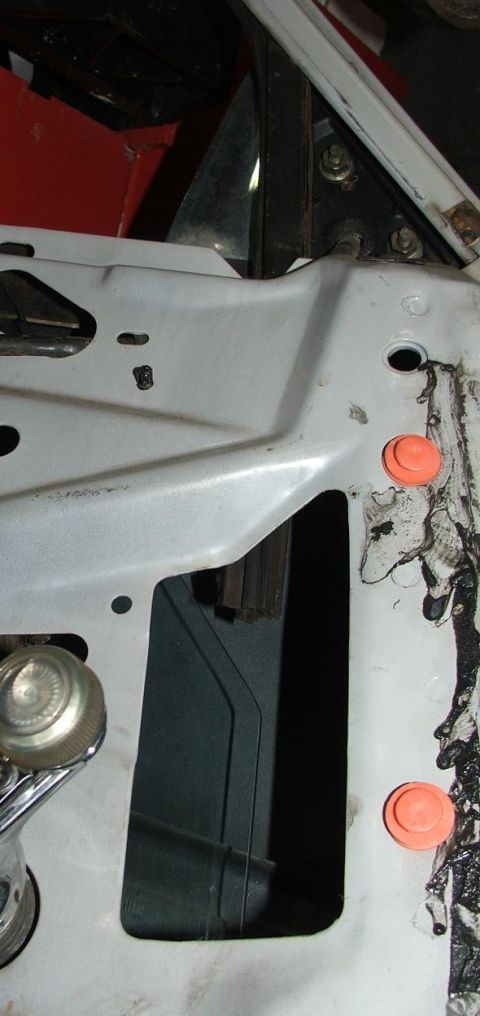 1991 Ford Crown Victoria LTD - Close-up view of a vehicle's door jamb, orange caps and a watermark from Supermotors.net.