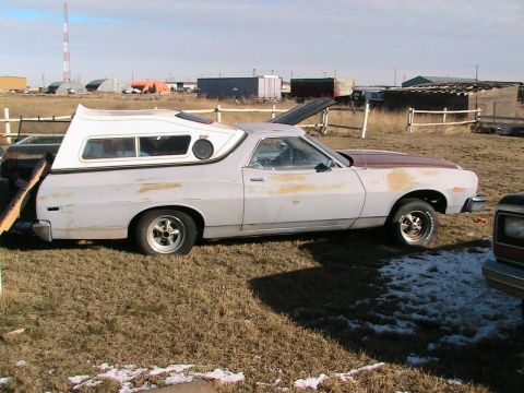 1973 Ford Ranchero - This 1973 Ford Ranchero is seen in primer with a white camper shell and a brown hood.