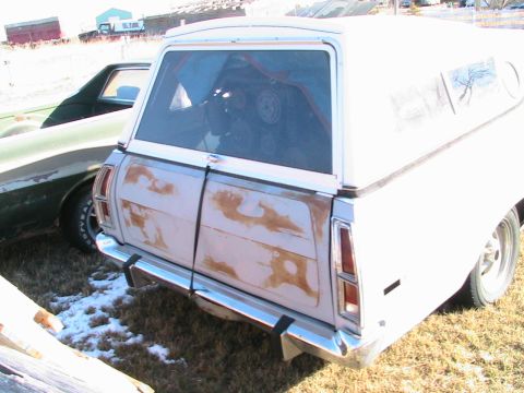 1973 Ford Ranchero - Rear view of a 1973 Ford Ranchero converted into a panel van, parked next to another vehicle.