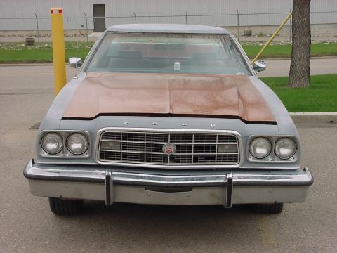 1973 Ford Ranchero - Front view of a 1973 Ford Ranchero with a two-tone paint scheme and chrome bumper.