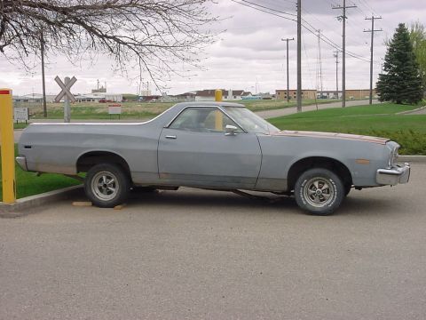 1973 Ford Ranchero - Side view of a gray 1973 Ford Ranchero parked outdoors.