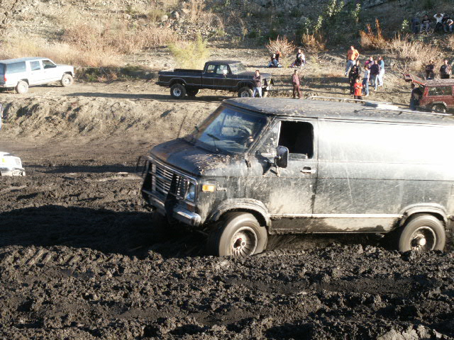Black van stuck in mud, front quarter view