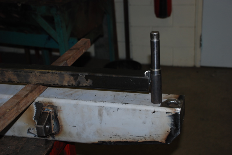 Metal fabrication work on a custom bumper, showing welding and a cylindrical metal piece attached