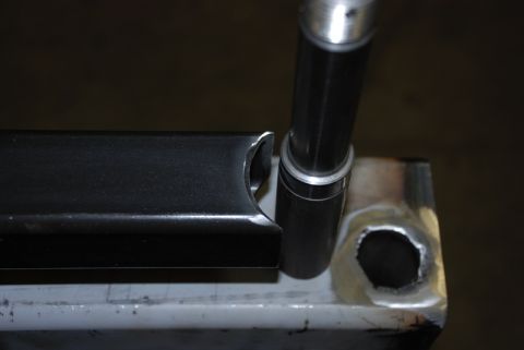 1996 Ford Bronco - Close-up of a metal component, possibly a bracket or frame piece, with a cylindrical rod nearby.
