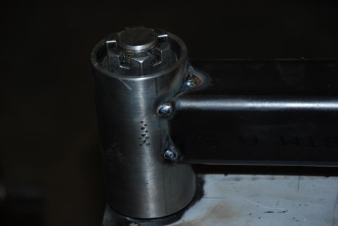1996 Ford Bronco - Welded metal bracket with a nut and bolt head, likely a custom part.