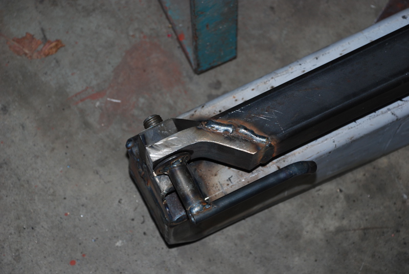 Close-up of a welded metal bracket with a bolt and nut