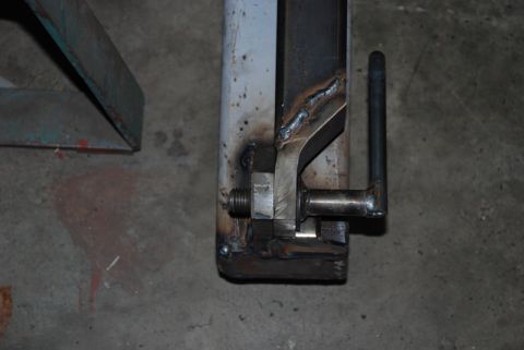 1996 Ford Bronco - A close-up view of a custom-fabricated metal bracket with a handle, showing welding and bolt assembly.