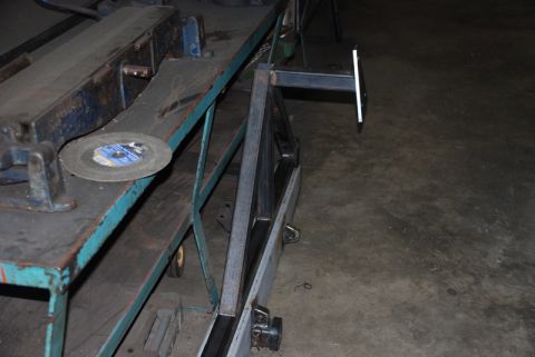 1996 Ford Bronco - A metal fabrication workshop scene with tools and unfinished metal parts.
