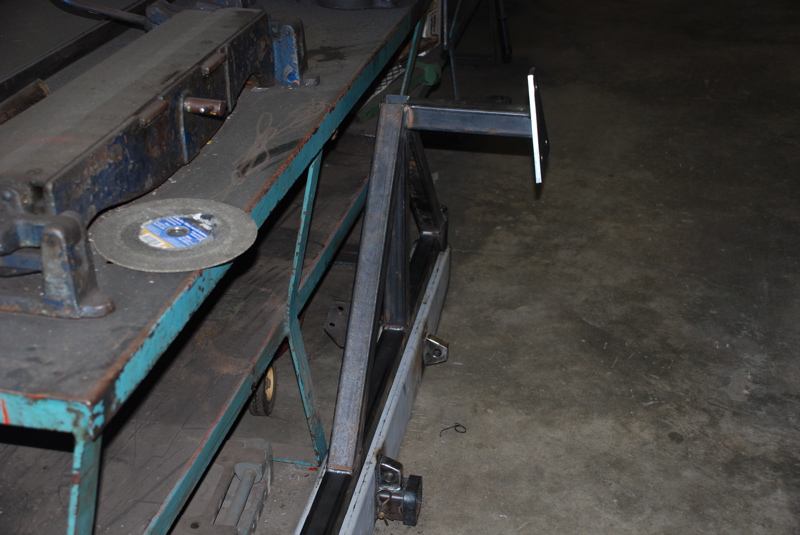 Metal cutting disc on a workbench next to a metal frame structure