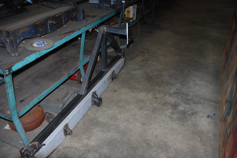 Custom rear bumper fabrication in progress, showing metal frame and grey bumper section