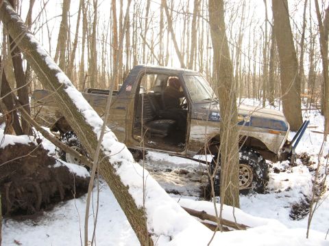 1979 Ford Bronco - This 1979 Ford Bronco appears to be stuck in a snowy wooded area, with its doors open and tires deep in the snow.