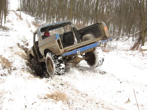 1979 Ford Bronco - A 1978 Ford Bronco navigates a snowy, muddy incline during winter conditions.