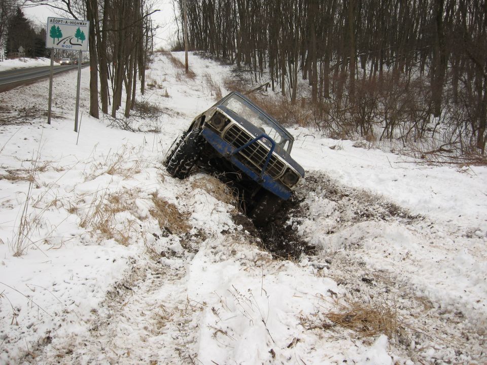 Blue 1979 Ford Bronco stuck in snow, front view