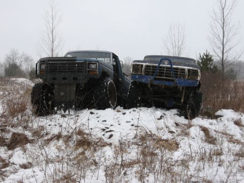 1979 Ford Bronco - Two modified 1979 Ford Broncos are shown in a snowy outdoor scene.