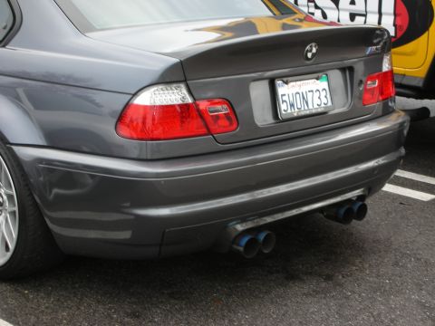 1998 Ford Crown Victoria - Rear view of a gray BMW M3 coupe showing the trunk badge, quad exhaust tips, and a California license plate.