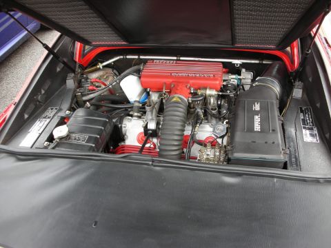 1998 Ford Crown Victoria - Engine compartment of a Ferrari with a red crackle-finish Quattrovalvole V engine and surrounding components.